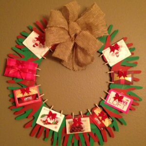 Gift ideas for teacher for christmas - Make a gift card wreath using student handprints as the wreath and clipping the gift cards on top.
